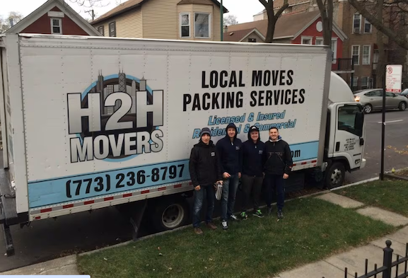 Movers for H2H pose in front of their moving van
